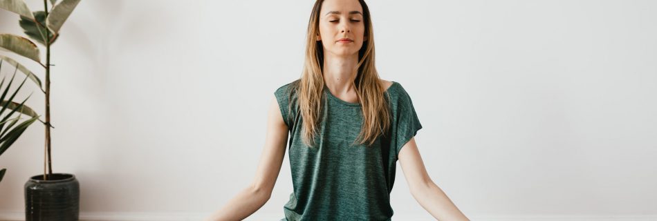 woman sitting with yoga pose and meditation expression