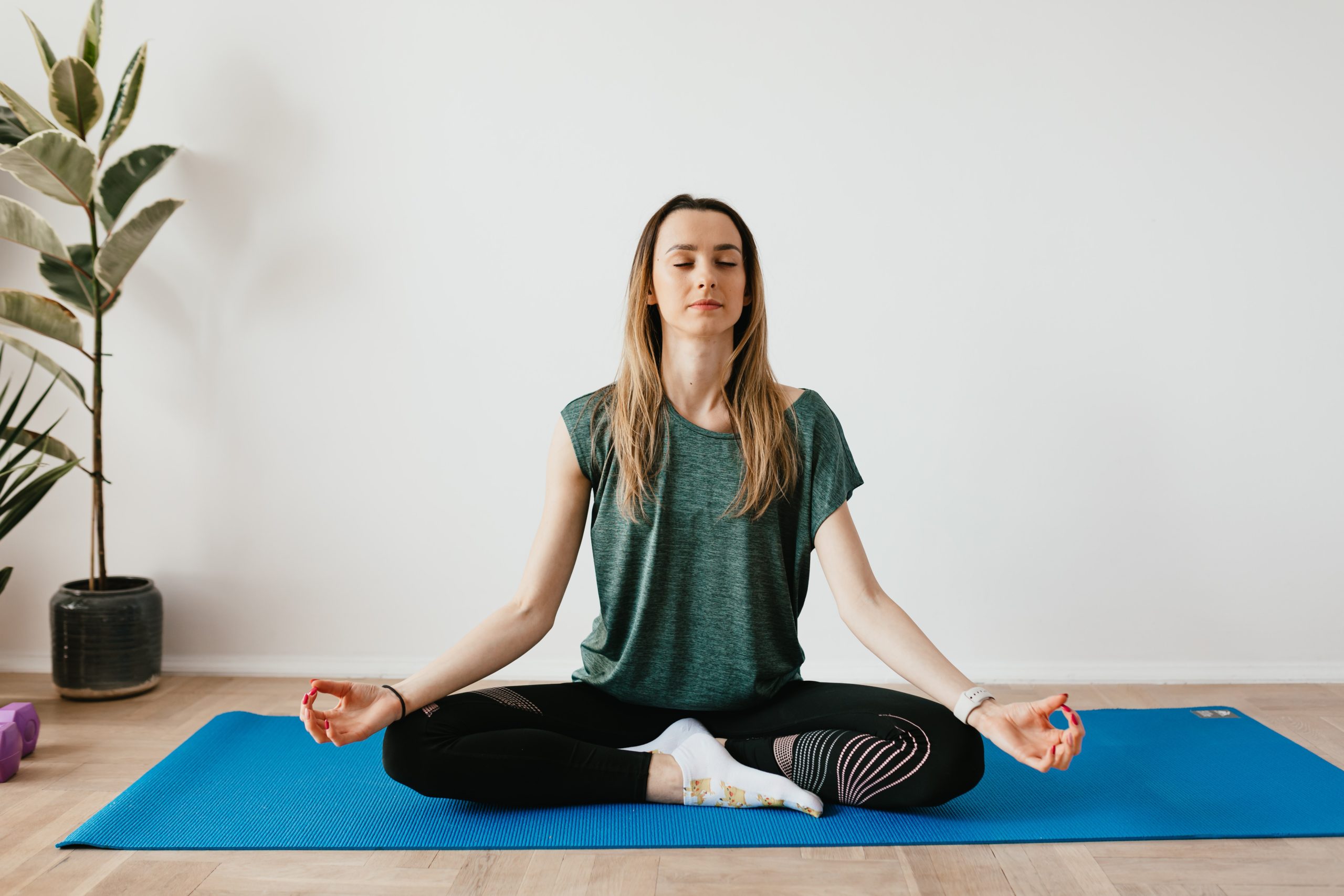 woman sitting with yoga pose and meditation expression